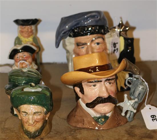 Royal Doulton large character jug, The Wizard, a smaller jug, Wyatt Earp, two ash pots and two small Toby jugs